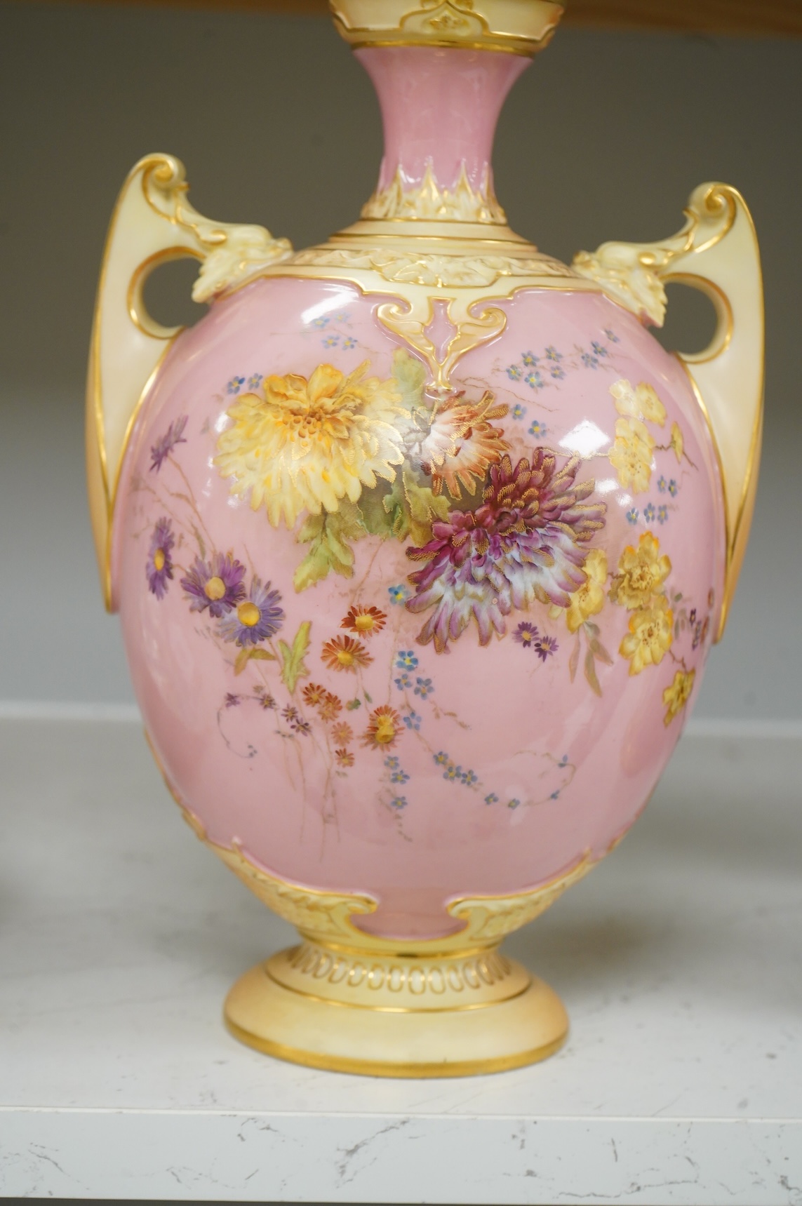A Royal Worcester floral decorated two handled vase and cover, 30cm